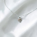 BlingbyAnvika 925 sterling silver heart pendant necklace with delicate chain on white satin fabric