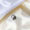BlingbyAnvika 925 sterling silver nose pin featuring a detailed heart design on a white satin background