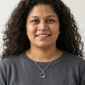 BlingbyAnvika sterling silver open heart pendant necklace with cubic zirconia stones worn by a smiling woman