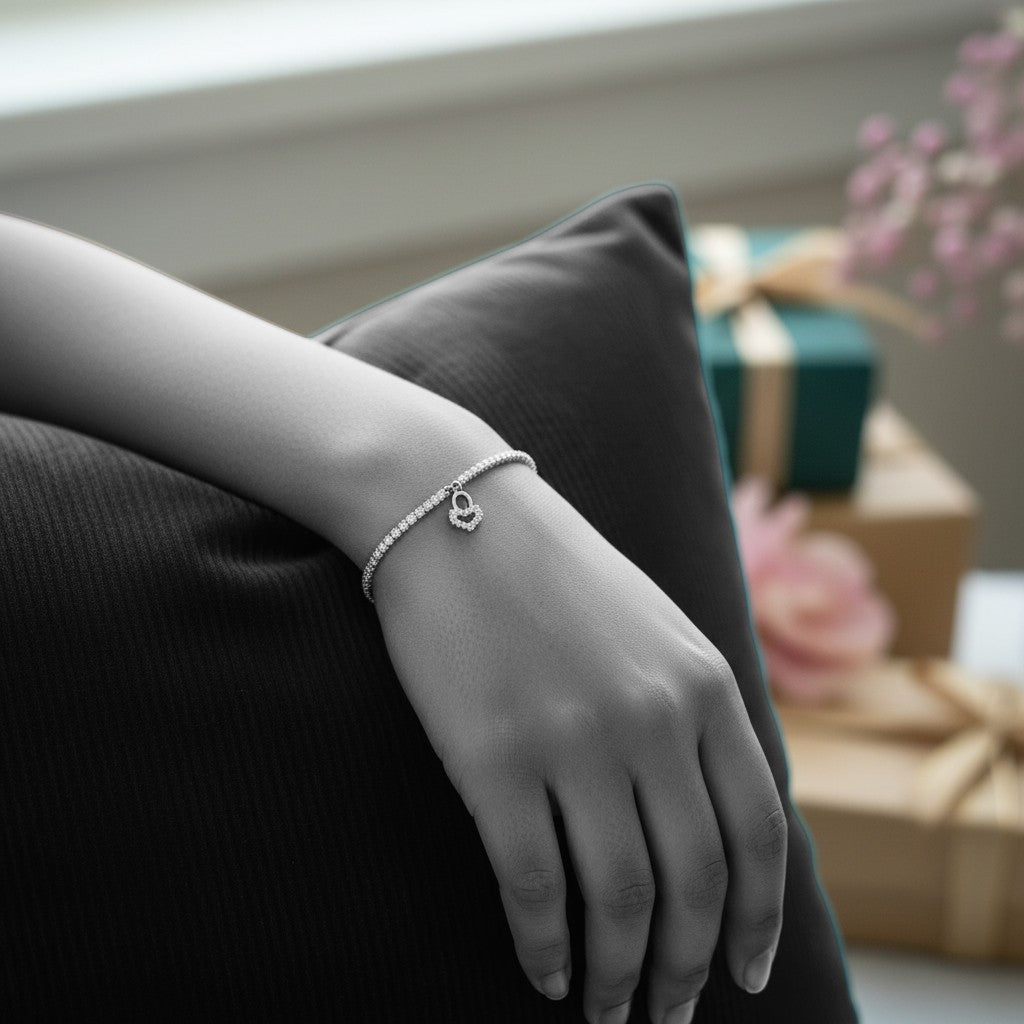 BlingbyAnvika 925 silver tennis bracelet with cubic zirconia and an infinity symbol charm.