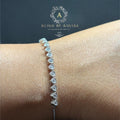 BlingbyAnvika 925 sterling silver bracelet with a delicate chain featuring small, sparkling heart-shaped stones.