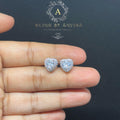 BlingbyAnvika heart-shaped sterling silver stud earrings featuring sparkling AAA-grade zircon stones on a hand.