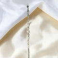 BlingbyAnvika 925 silver infinity link chain bracelet with sparkling accents on a soft white satin background