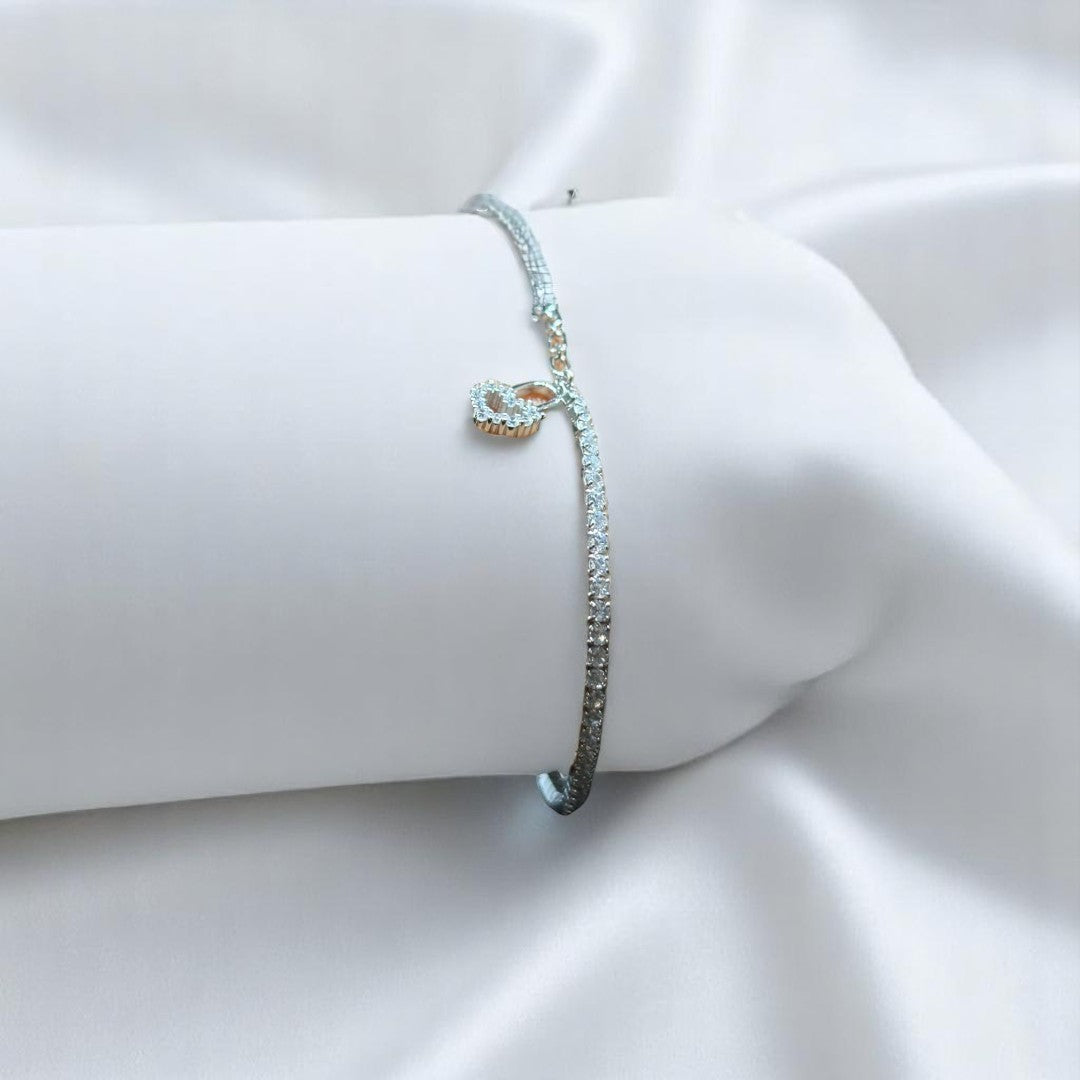 BlingbyAnvika 925 silver tennis bracelet with cubic zirconia and an infinity symbol charm.