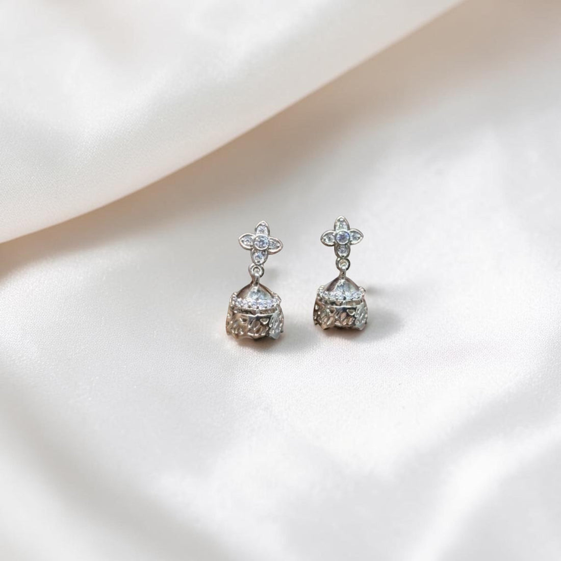 BlingbyAnvika sterling silver jhumka earrings with intricate detailing and cubic zirconia stones.