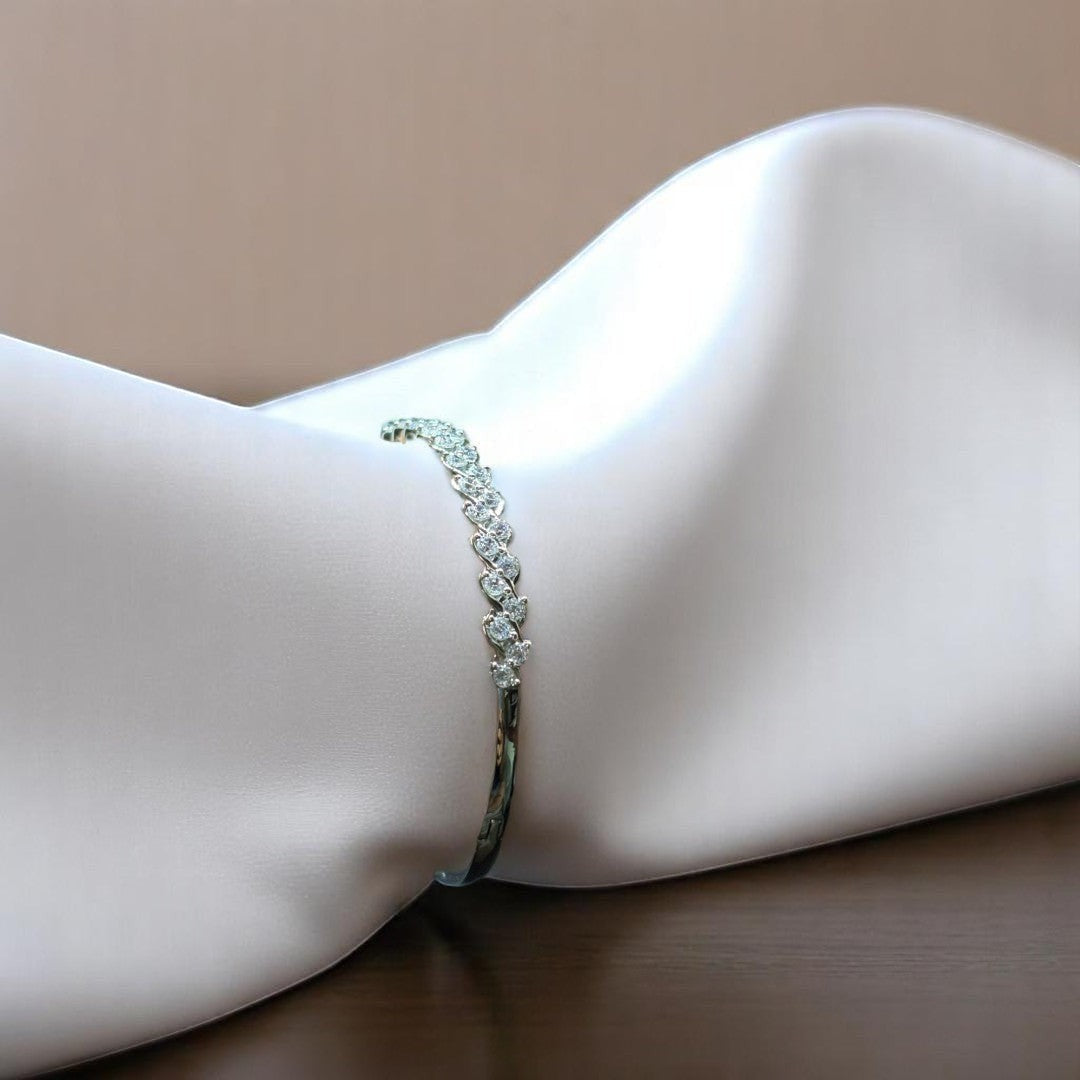 BlingbyAnvika 925 sterling silver bracelet featuring a delicate leaf design with shimmering stones on white fabric.