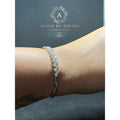 BlingbyAnvika 925 sterling silver bracelet featuring a delicate leaf design with shimmering stones on a wrist.