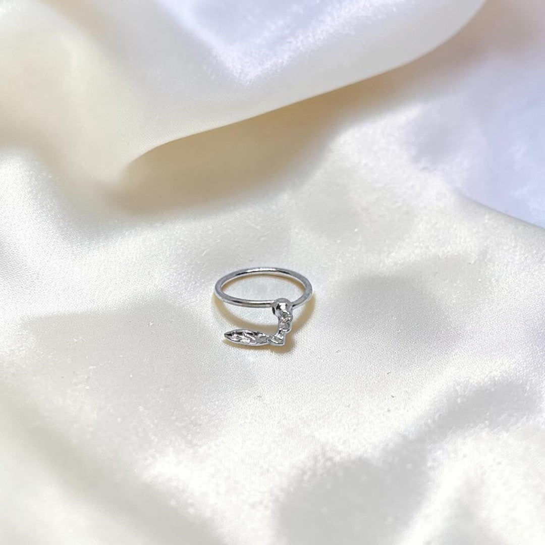 BlingbyAnvika 925 sterling silver nose ring featuring a delicate hanging leaf charm on a soft white satin background.