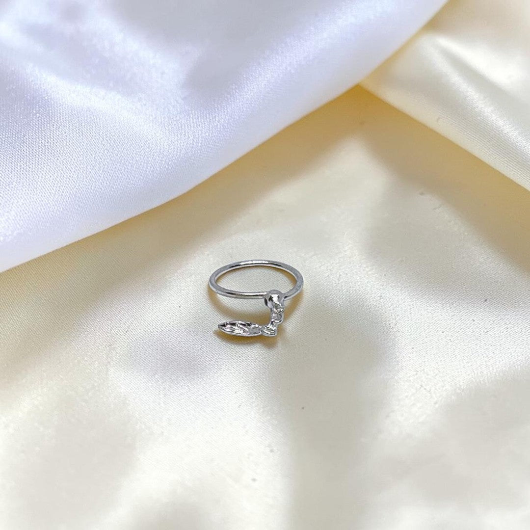 BlingbyAnvika 925 sterling silver nose ring featuring a delicate hanging leaf charm on a soft white satin background.