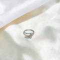 BlingbyAnvika 925 sterling silver nose ring featuring a delicate hanging leaf charm on a soft white satin background.