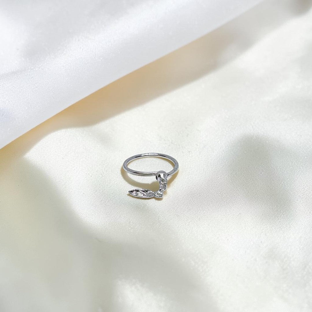 BlingbyAnvika 925 sterling silver nose ring featuring a delicate hanging leaf charm on a soft white satin background.