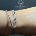 BlingbyAnvika 925 sterling silver linked chain bracelet with pavé accents worn on a wrist next to a sleek silver kada.