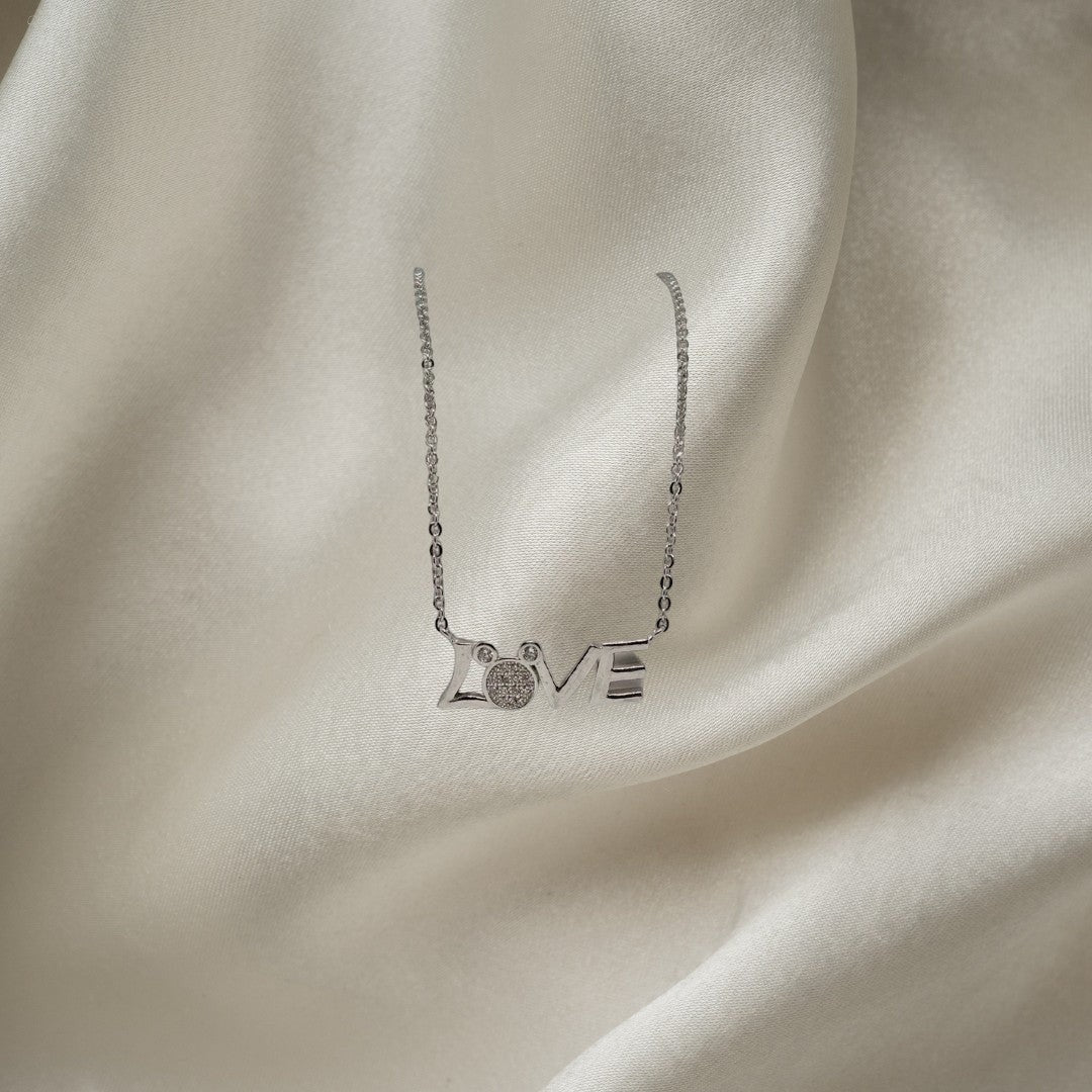 BlingbyAnvika 925 sterling silver necklace with the word LOVE in script, featuring a circular charm with small stones on the letter O.