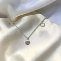BlingbyAnvika sterling silver necklace with oval pendant and circle accents. Minimalist, iridescent shimmer.