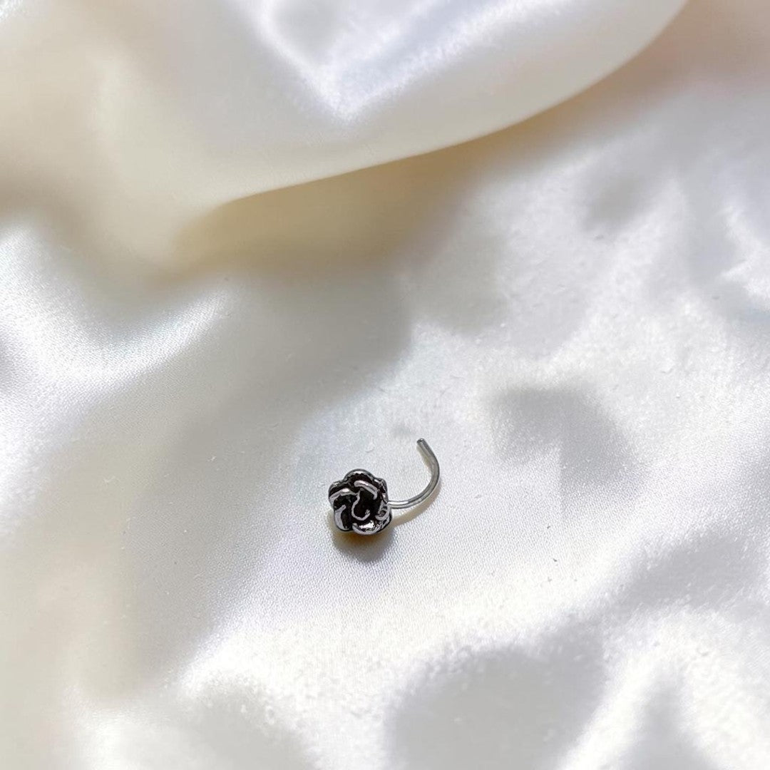 BlingbyAnvika 925 sterling silver nose pin featuring a detailed rose flower design on a white satin background