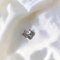 BlingbyAnvika 925 sterling silver septum ring with ornate tribal-inspired bead detailing on a white satin background.