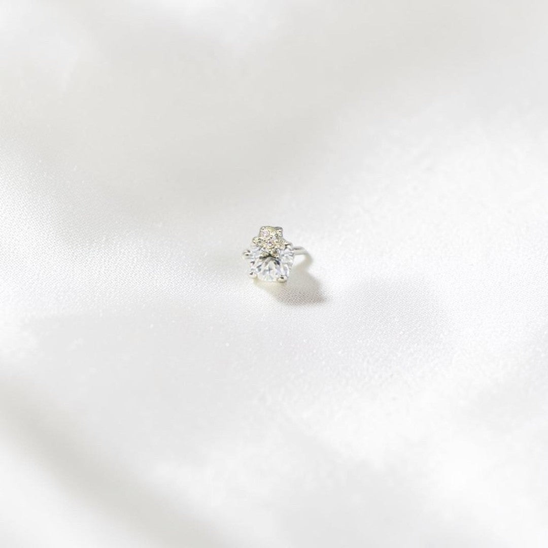 BlingbyAnvika 925 sterling silver nosepin with a central sparkling stone and a small star accent.