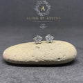 BlingbyAnvika sterling silver star stud earrings with sparkling AAA-grade zircon stones on a natural stone surface.
