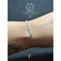 BlingbyAnvika 925 sterling silver bracelet with small clear stones on a chain, worn on a woman's wrist.
