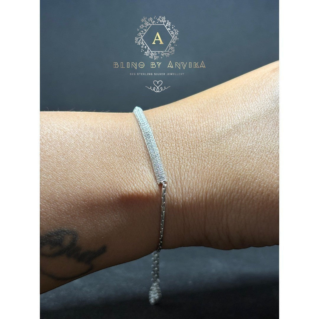 BlingbyAnvika 925 sterling silver bracelet with small clear stones on a chain, worn on a woman's wrist.