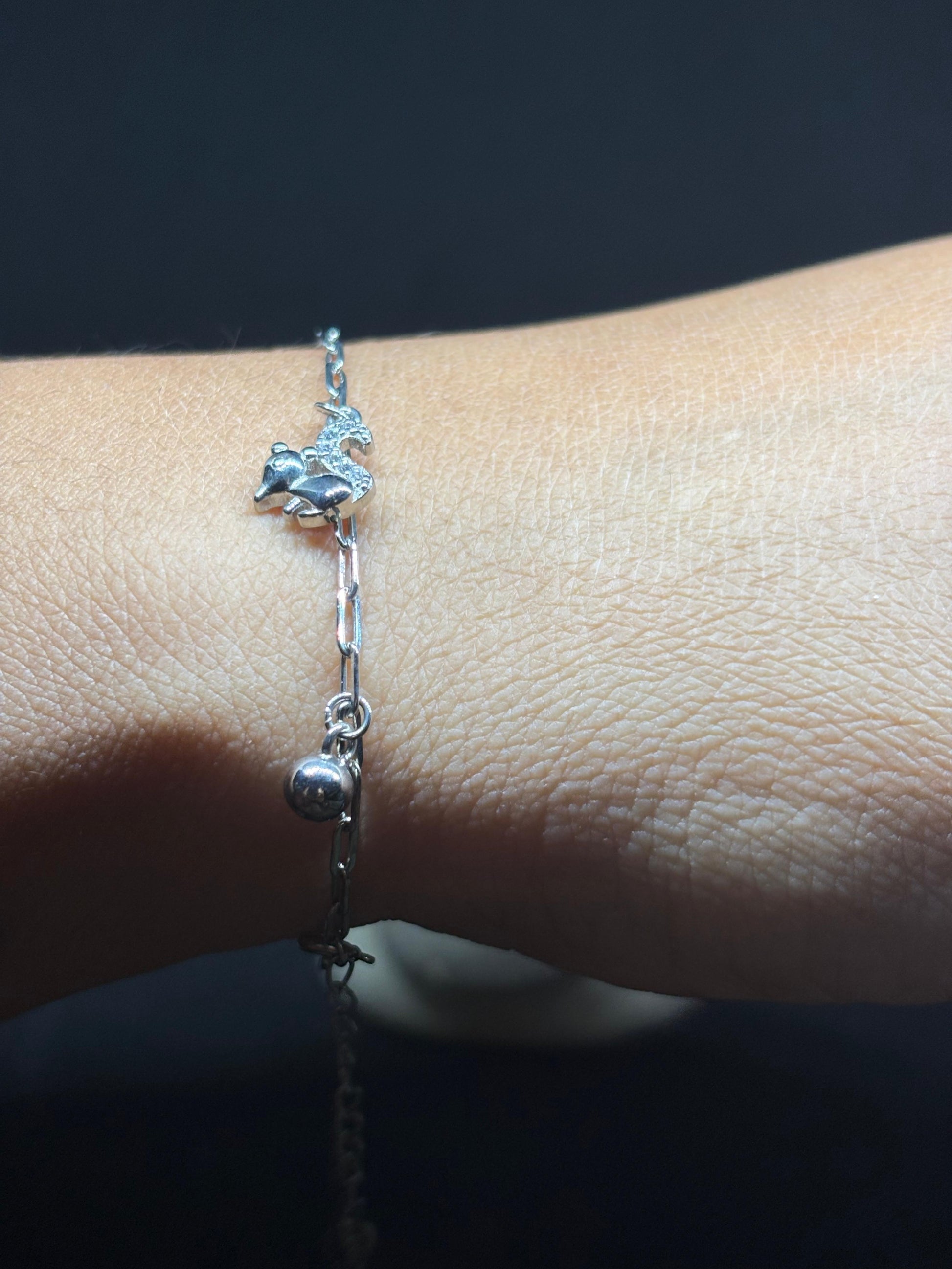 BlingbyAnvika silver-tone adjustable bracelet with a sparkling unicorn charm and dangling ball.