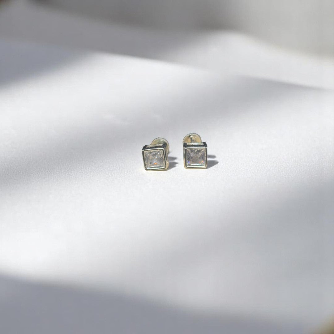 BlingbyAnvika square stud earrings featuring AAA-grade zircon stones set in 92.5 sterling silver on white fabric.