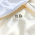 BlingbyAnvika square stud earrings featuring AAA-grade zircon stones set in 92.5 sterling silver on white fabric.