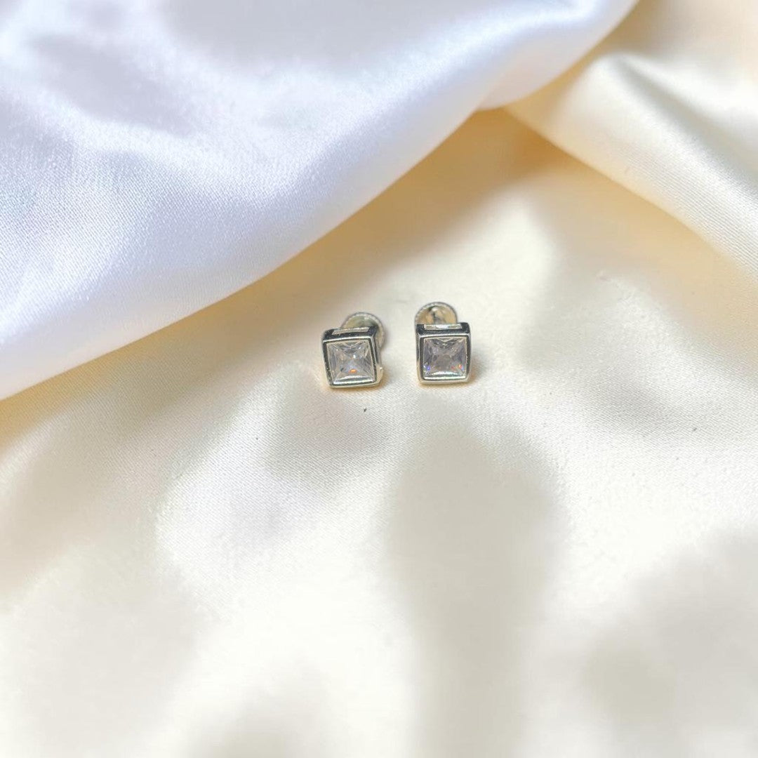 BlingbyAnvika square stud earrings featuring AAA-grade zircon stones set in 92.5 sterling silver on white fabric.