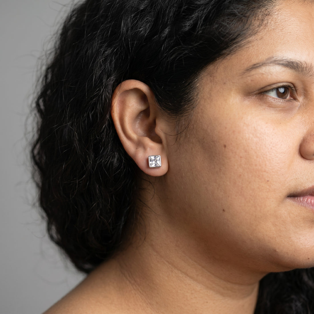BlingbyAnvika square stud earrings featuring AAA-grade zircon stones set in 92.5 sterling silver on white fabric.