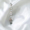 BlingbyAnvika sterling silver bolo bracelet with cubic zirconia and fleur-de-lis charms. Adjustable clasp.