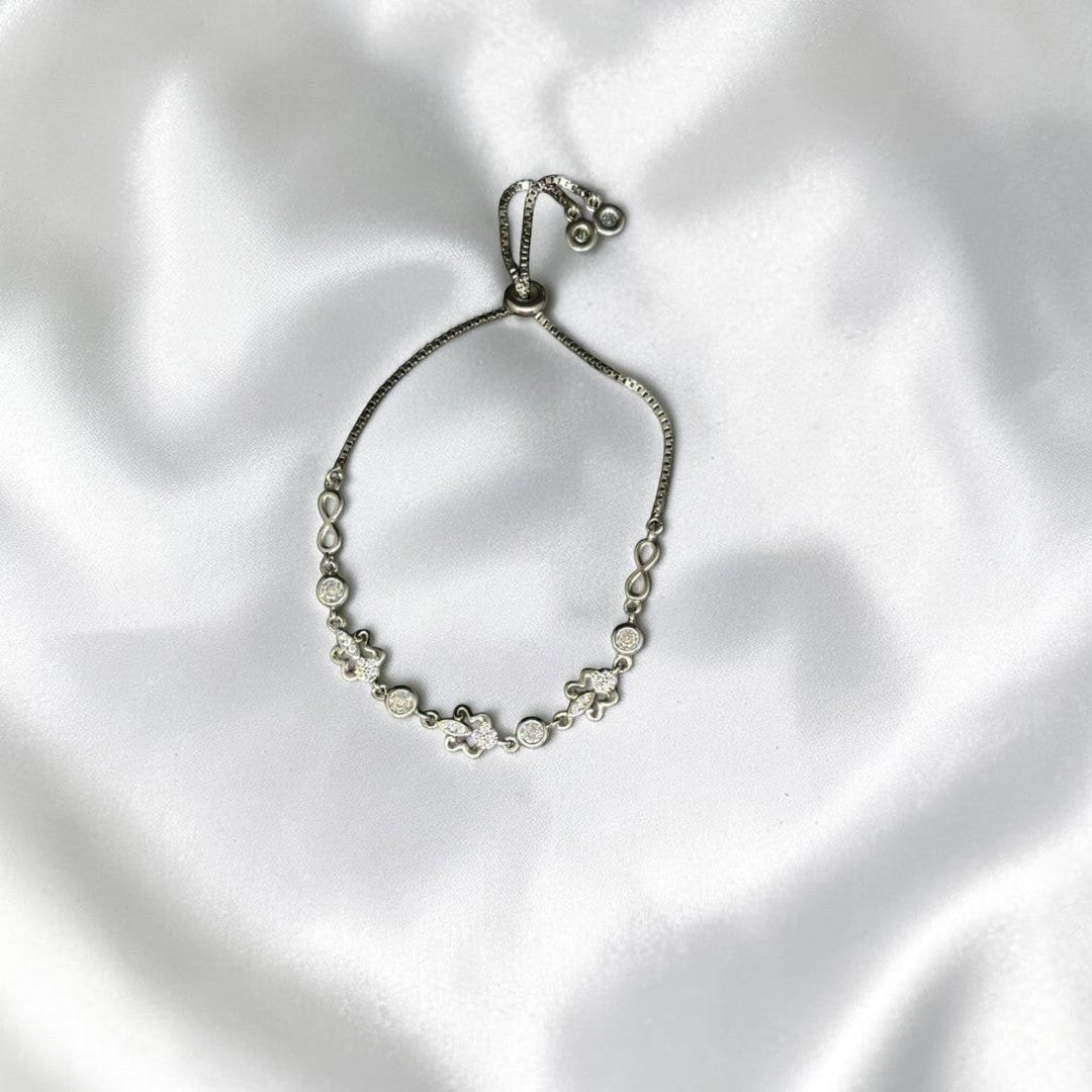 BlingbyAnvika sterling silver bolo bracelet with infinity symbols and cubic zirconia. Adjustable clasp.
