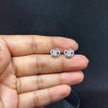 BlingbyAnvika sterling silver heart-shaped stud earrings with AAA-grade zircon stones held in a hand.